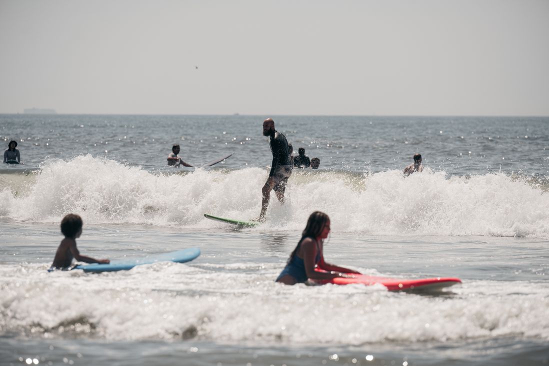 Surfers ride waves at Rockaway Beach on Saturday, July 23rd.